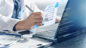 Medical professional using laptop with documents